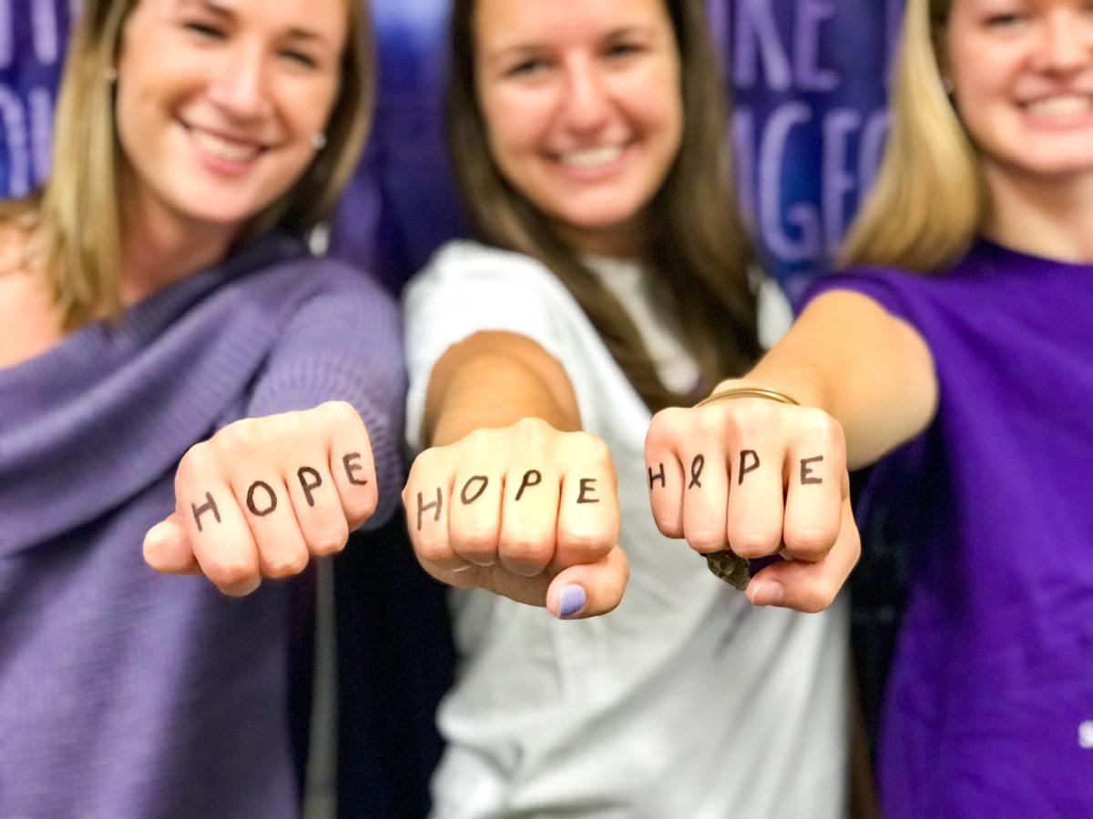Exec Board members with one of Relays themes: the power of hope (Photo courtesey of Jillian Rogers ’18).