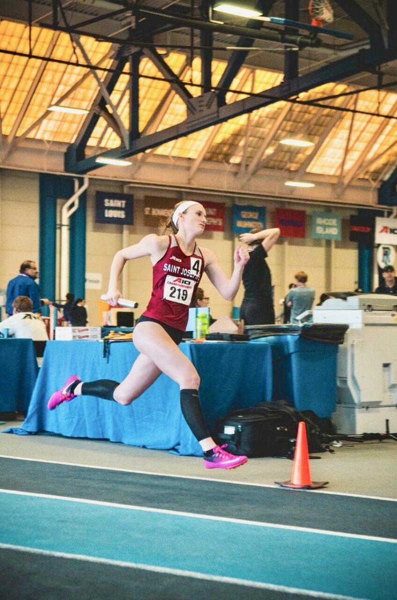 Sophomore Caroline Duffy runs a relay 
(Photo by Dylan Eddinger ’19).