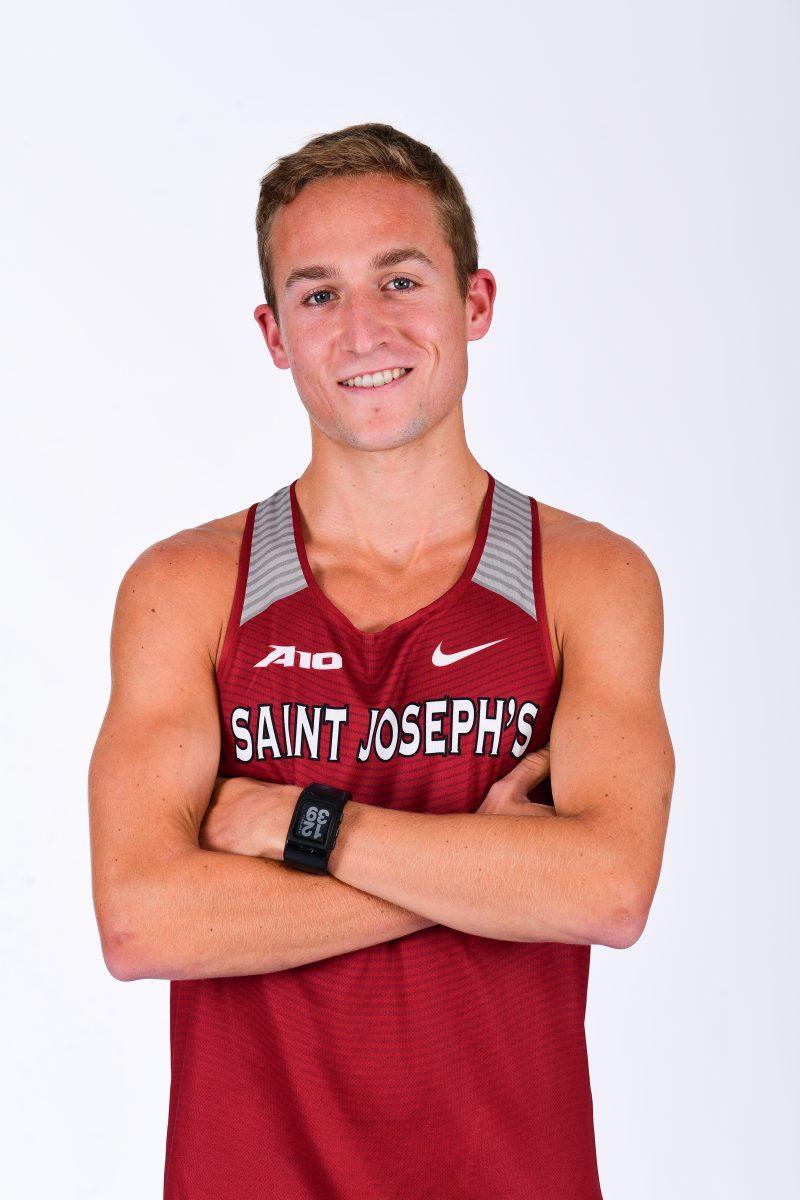 Dan Savage ’18 poses in his St. Joes mens cross country gear (Photo by Sideline Photos LLC).