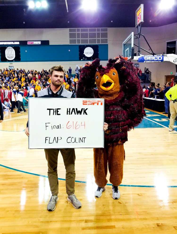 Stephen Pratt poses with the Hawk mascot, who flapped its wings 6164 time during St. Joes mens basketball game versus West Virginia University 
PHOTOS: COASTAL CAROLIINA UNIVERSITY ATHLETICS