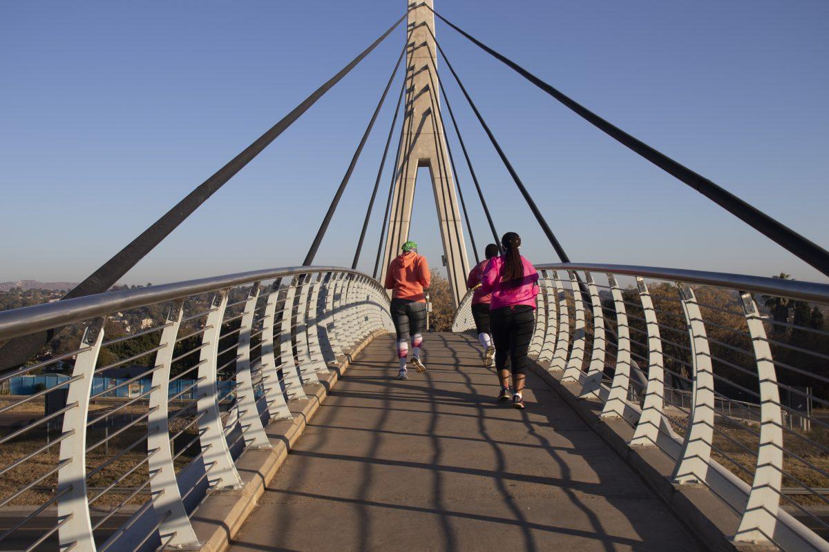 Runners cross a bridge on a weekend run with the Run Zone running club. PHOTO: Jackie Collins 21