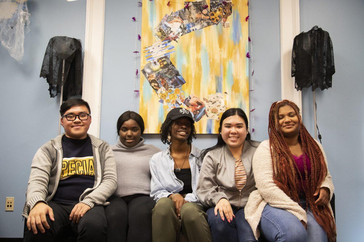 The Hawks in Flight executive board (from left to right) Long Huynh ’21, Fatmata Sakho ’21, Makiah Stephens ’22, Elizabeth Le ’21,
and Sierra Long ’21, sit in front of the canvas that was taken off the wall. PHOTO: MITCHELL SHIELDS ’22/THE HAWK