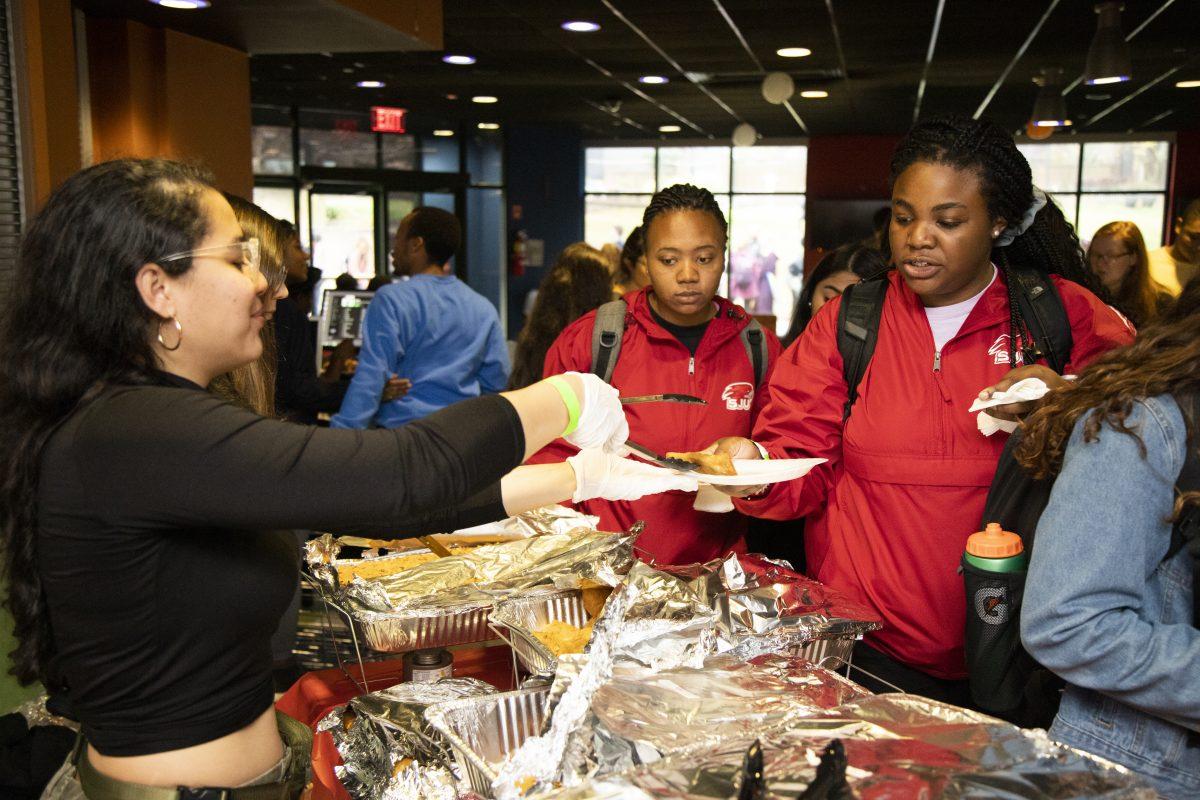 Carla Rodriguez ’20 of LSA serves students at Taste of the World. PHOTOS: Mitchell Shields ’22