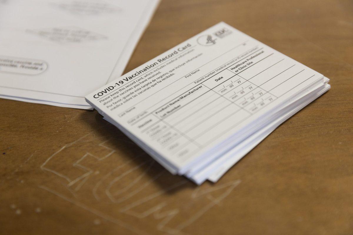 Blank vaccination cards at the Edward O’Malley Athletic Center. PHOTO: MITCHELL SHIELDS 22/THE HAWK