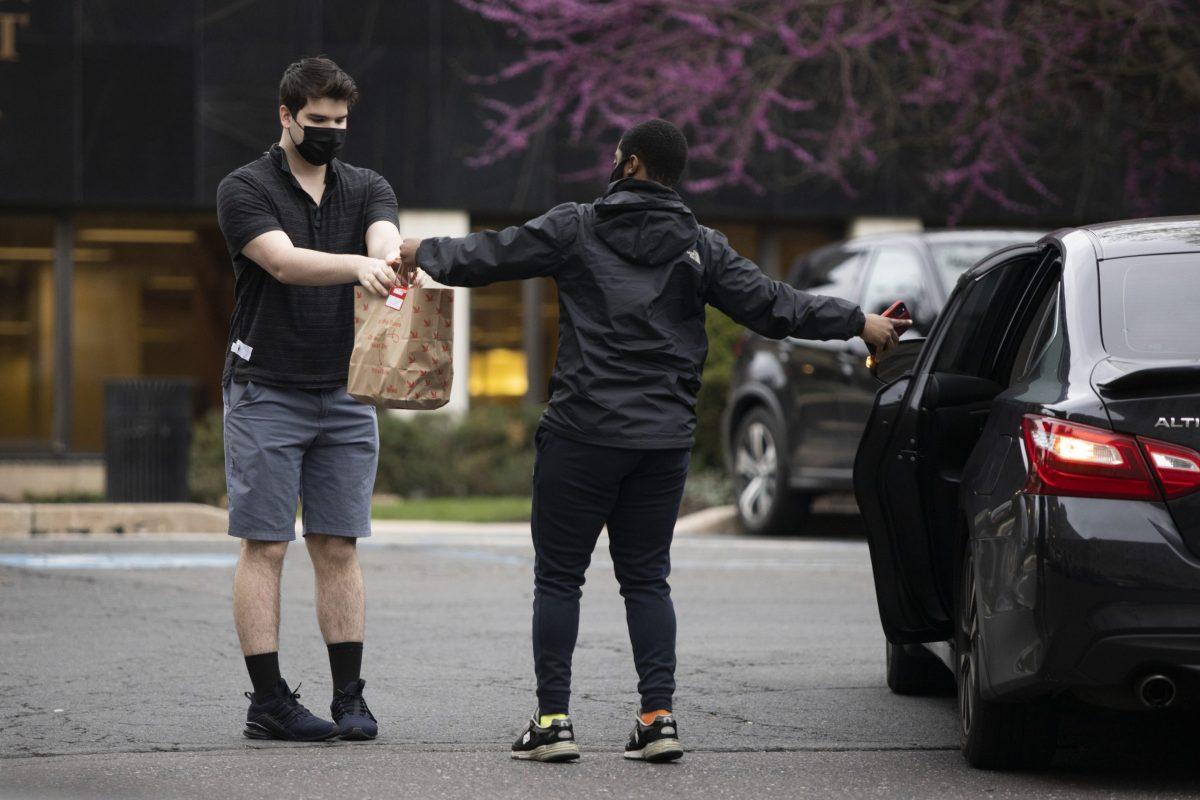 A student picks up a food delivery outside Villiger Hall on April 12.
PHOTO: MITCHELL SHIELDS ’22/THE HAWK