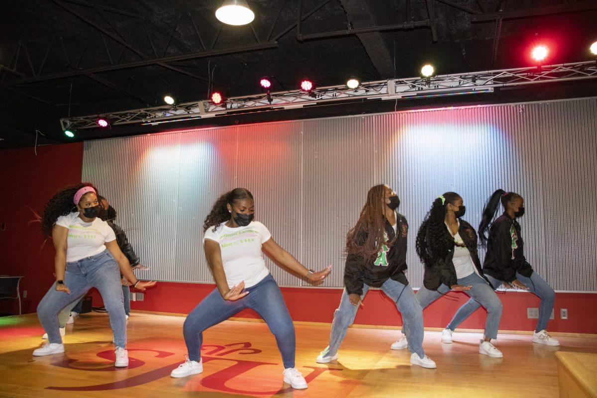 Members of Alpha Kappa Alpha Sorority Inc. do a step routine at the “Meet the Greeks” event in the Perch Oct. 8. 