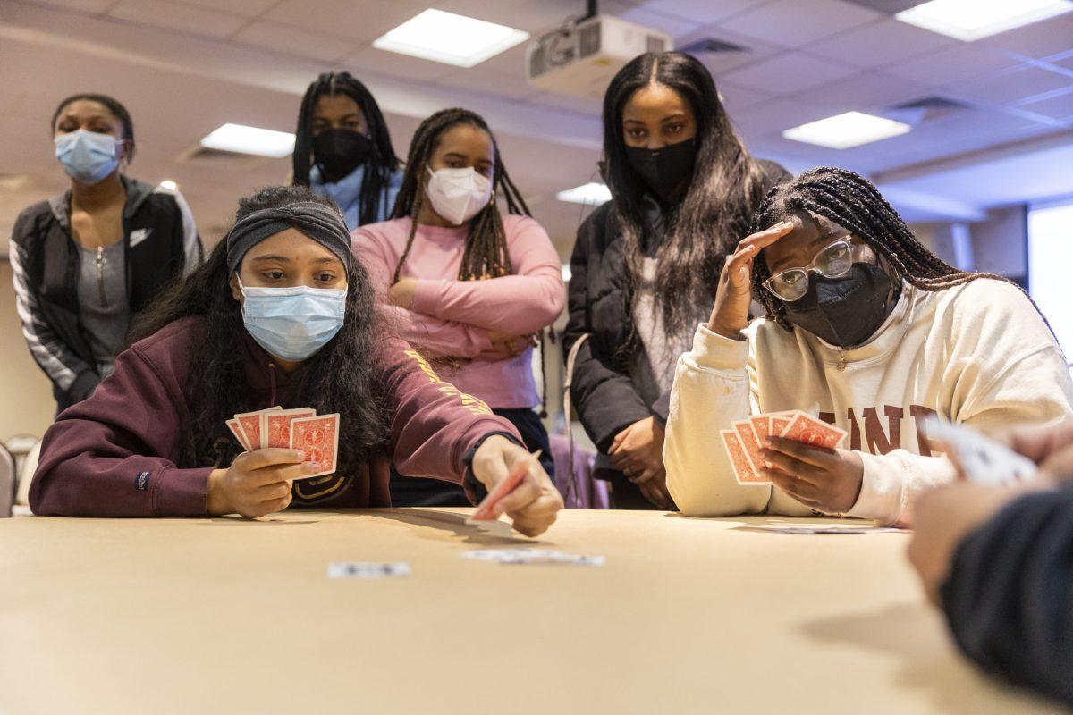 Kelsey Welsh ’22 (left) plays a card during a demonstration of how to play Spades at BSU’s Spades Night on Feb. 4. PHOTOS: MITCHELL SHIELDS 22/THE HAWK 