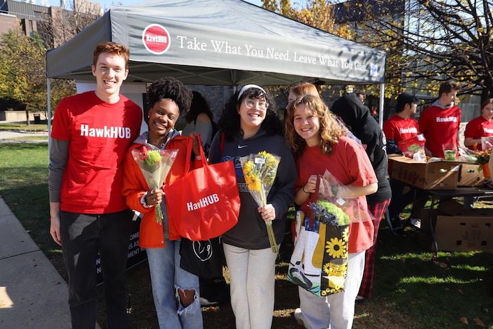 Kevin Hoban ’24, Taryn Bellamy ’24, Adamaris Bovasso ’24 and Anna
Owens ’24 at the HawkHUB and Sharing Excess Trader Joe’s pop-up Nov.
11 on Campion Lawn. PHOTO: ALLIE MILLER ’24/THE HAWK