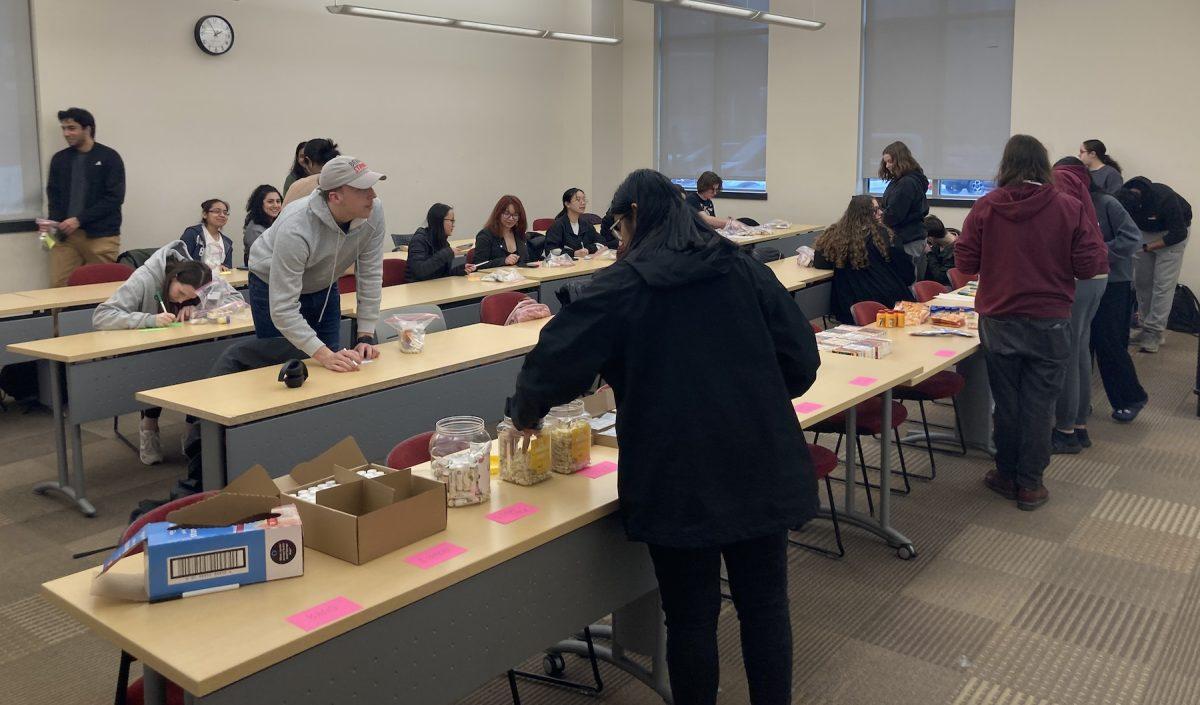 Members of St. Joes chapter of Circle K International and SSMLS work to assemble cold and flu kits, Feb. 23.