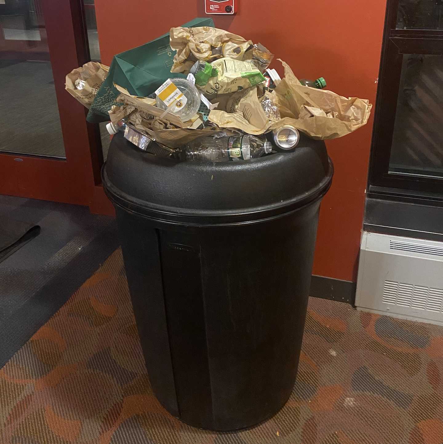 A trash can overflowing in Merion Hall at 5:38 p.m. Nov. 20, 2023. PHOTO: THE HAWK