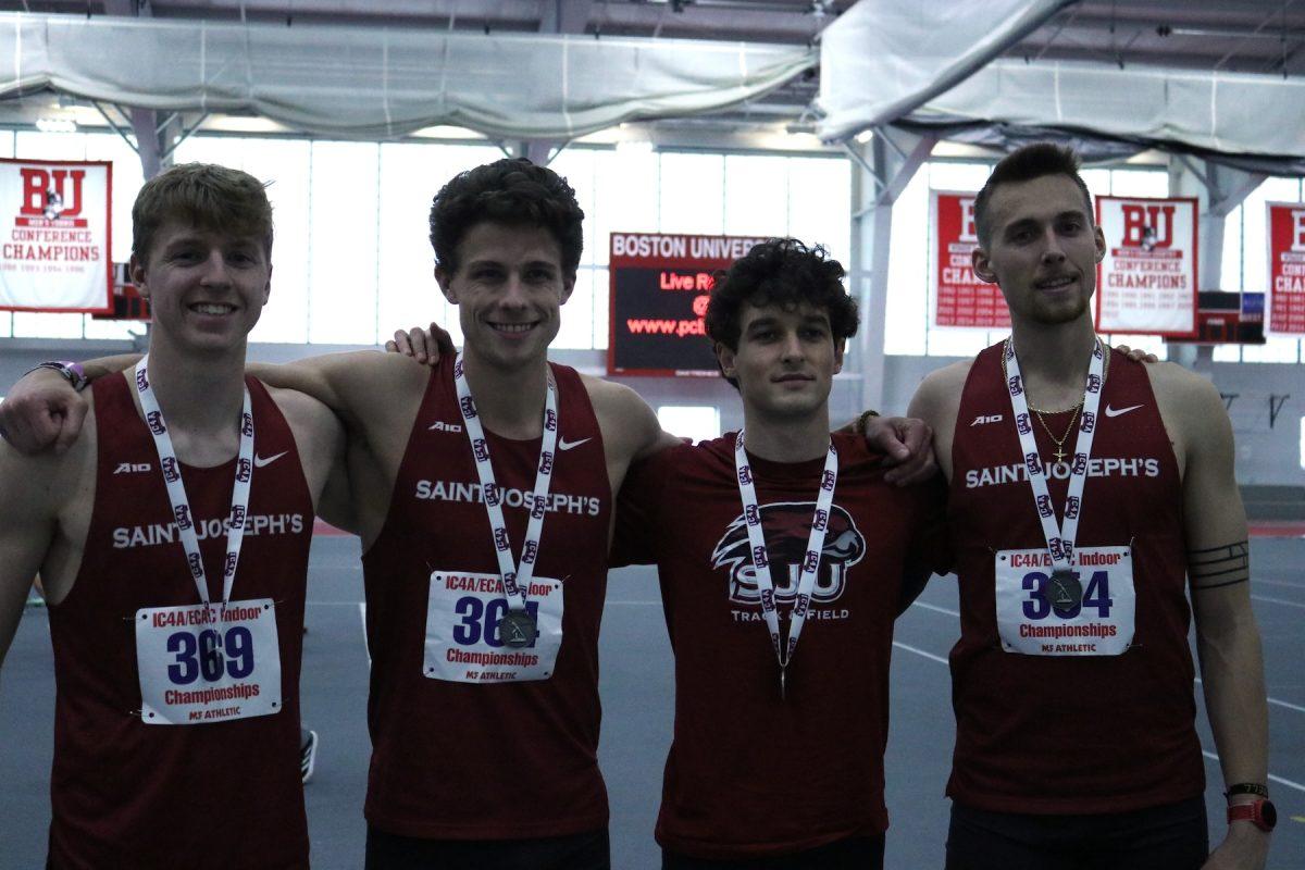 Photo of Junior Josh Thaler, senior Owen Moelter, junior Graham Phillips and senior Gavin Campbell at the 2024 IC4A/ECAC Indoor Championships in Boston, Mass wearing medals, after breaking school record in the 4 by 800 meter relay