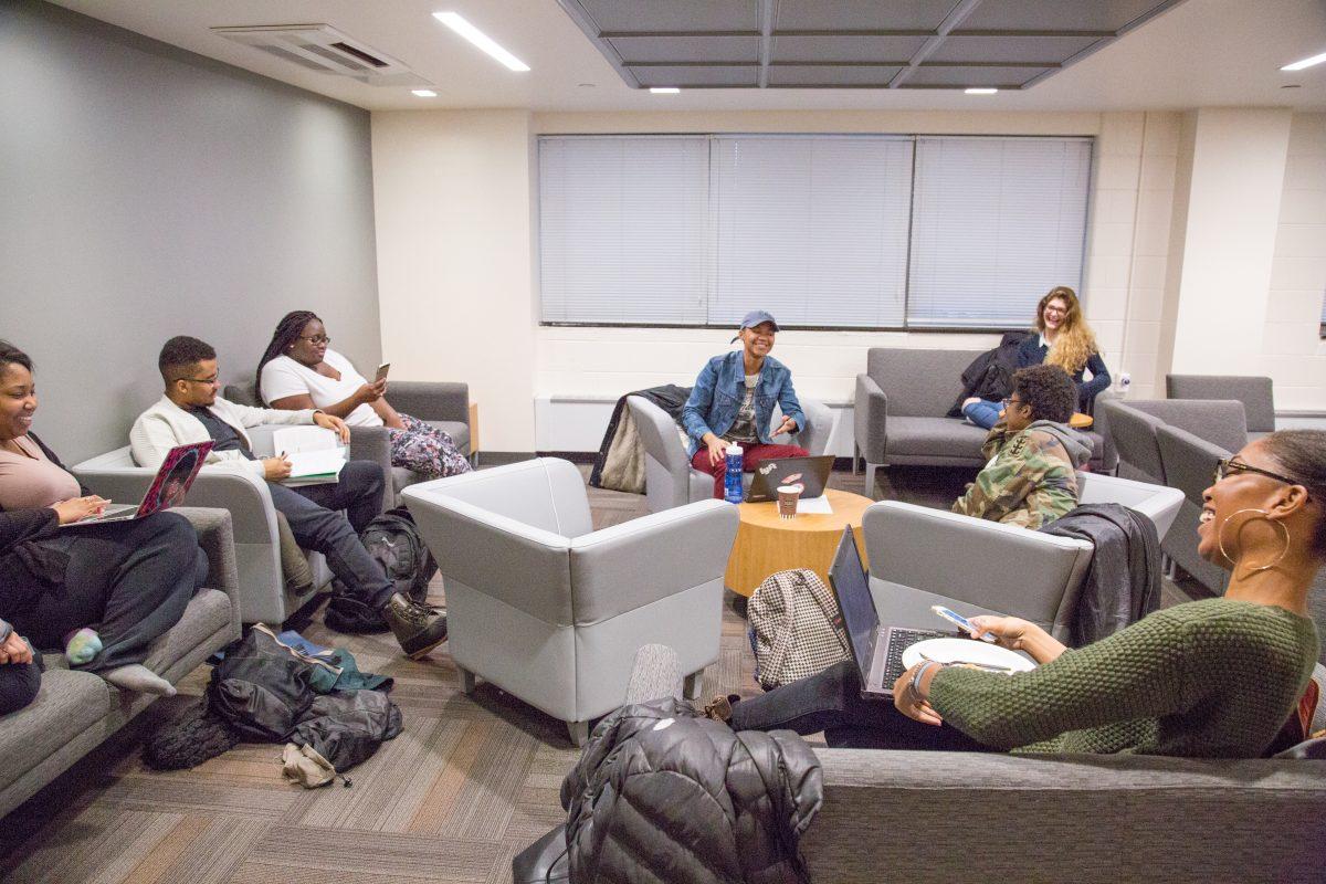 Students socialize in lounge area before class.