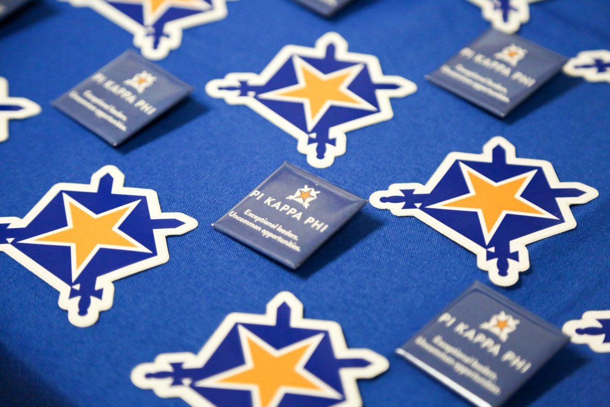 Pi Kappa Phi pins line a table in Campion Student Center (Photo by Luke Malanga 20).