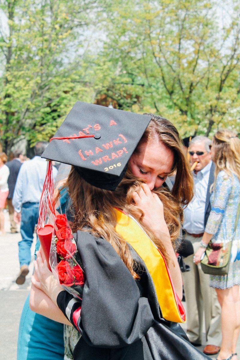 Students embrace at Commencement (Photo by Kaitlyn Neinstedt, ’17).