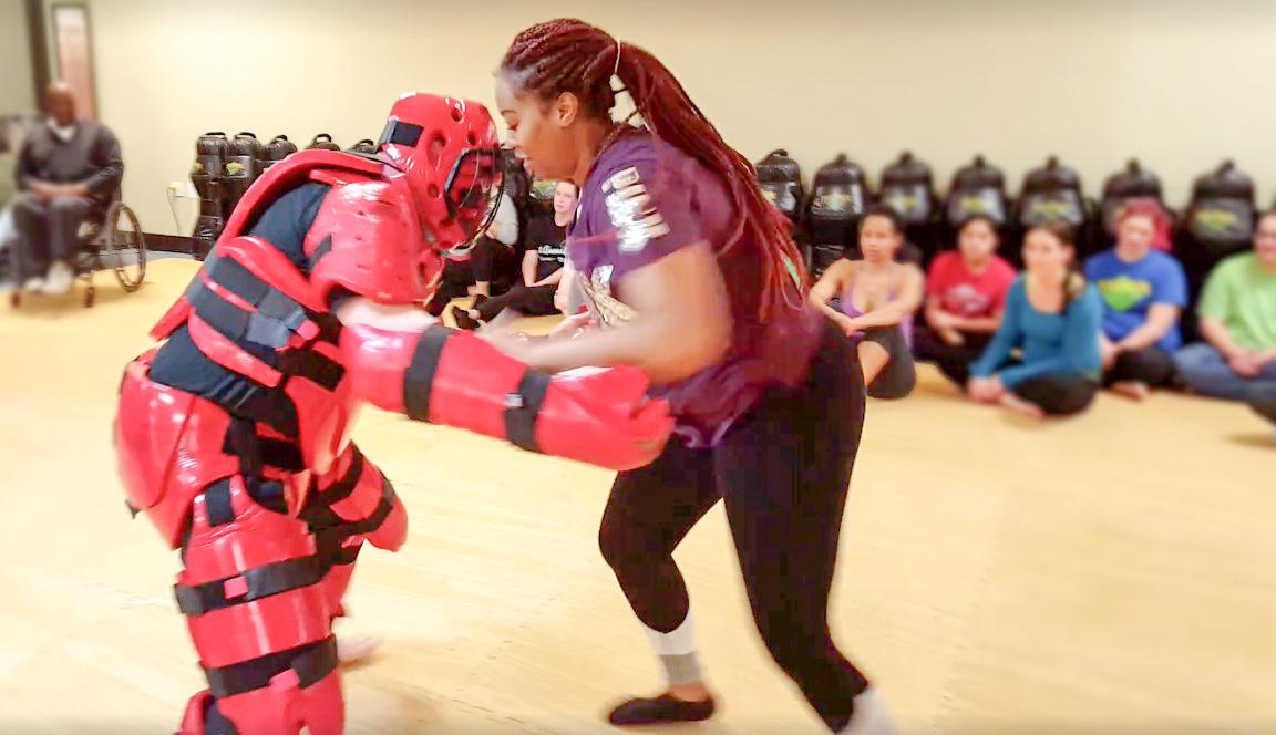 A participant tries out moves on a live fighter at Premier Martial Arts (Photo courtesy of Katie White, 17).