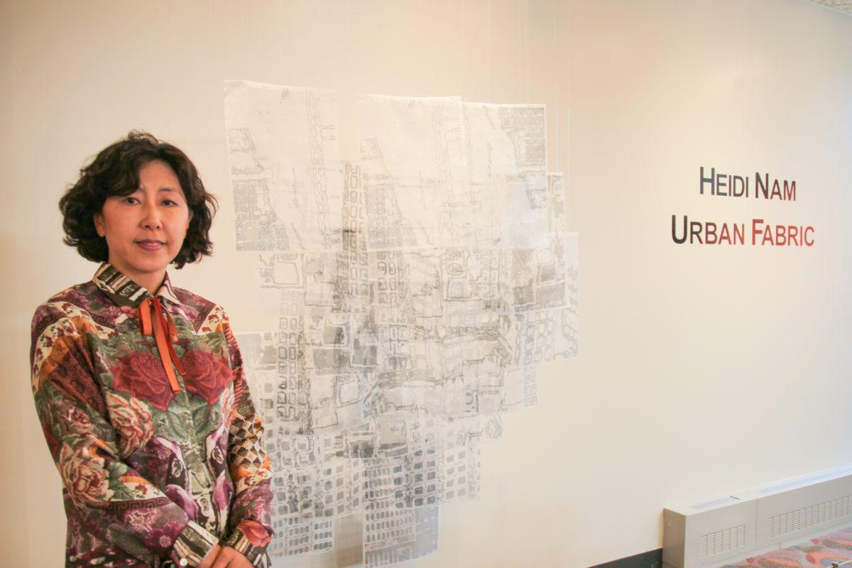 Heidi Nam poses with her favorite piece in her exhibition Urban Fabric (Photo by Rose Weldon 19).