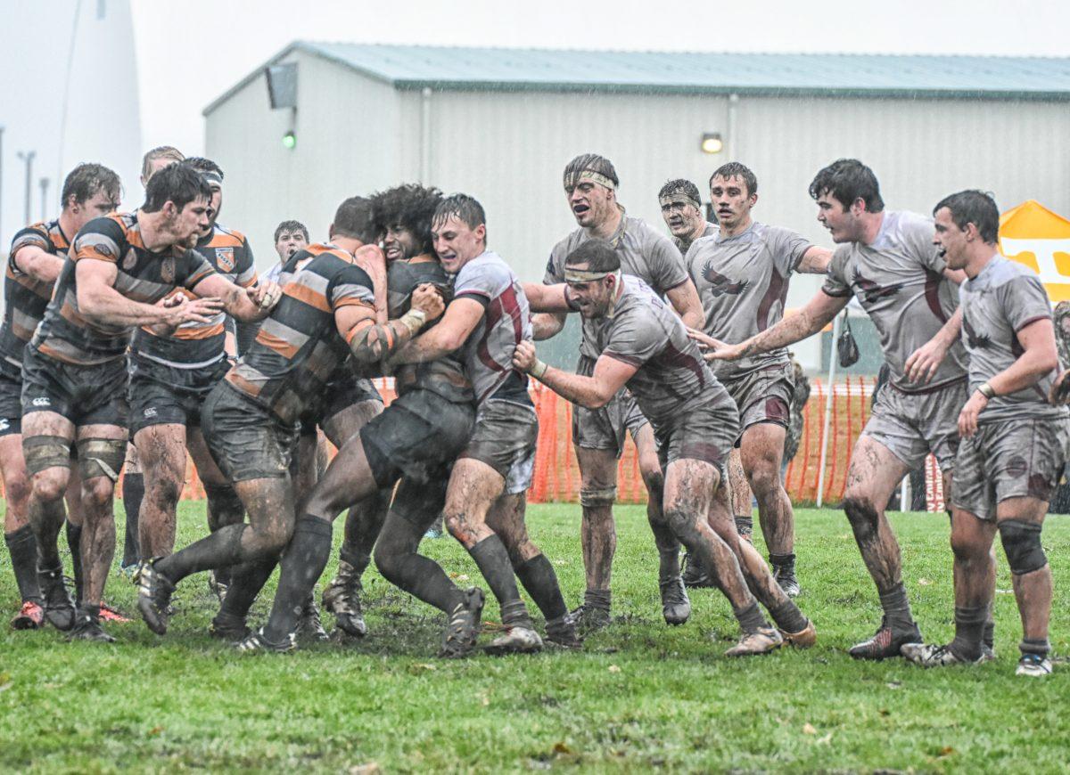 The Hawks battle the University of Tennessee through the mud (Photo by Peter Curcio).