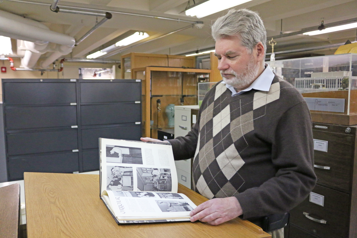Dixon admiring one of the yearbooks from the archives (Photo by Matthew J. Haubenstein, M.A., ’17).
