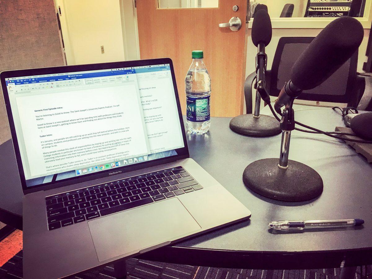 The recording space is set up with show notes and microphones (Photo by Jeffrey Martin ’04, ’05, M.A.).