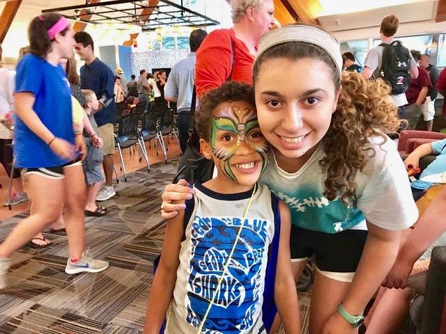 Juliette Joseph ’20, one of the Kinney SCHOLARS, poses with one of the Camp Kinney attendees in 2017. 