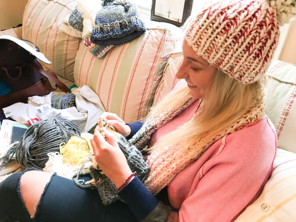 Greta Shanley ’18 knits personalized hats for customers at St. Joe’s (Photo by Cassandra Muratore ’18).   