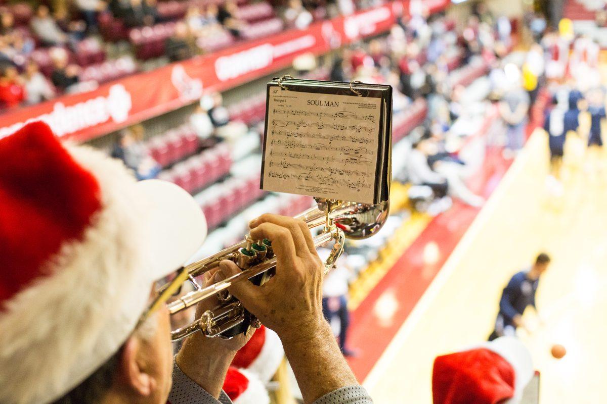 A member of the Pep Band plays the trumpet during warm-ups for a mens basketball game (Photo by Luke Malanga ’20).