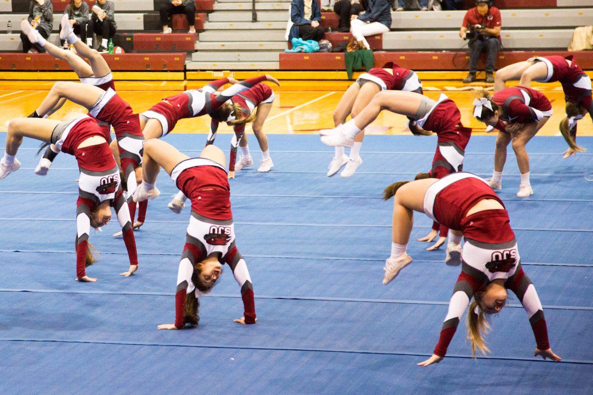 Cheerleaders perform their competition routine in front of a crowd in Hagan Arena (Photo by Luke Malanga '20).