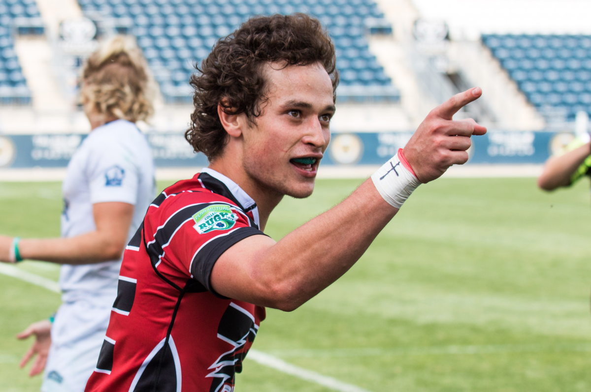 Noah Niumataiwalu points to the St. Joes crowd after scoring a try in the Collegiate Rugby Championship – a cross and MD15 written on his wrist tape (Photo by Luke Malanga 20).