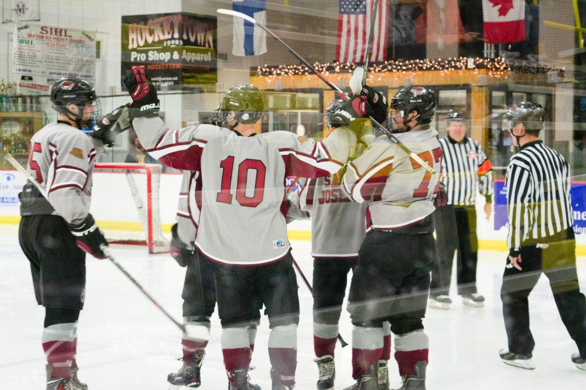 The men’s club ice hockey team celebrates their win after a game (Photo by Kaitlyn Patterson ’20).