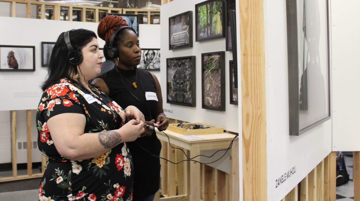 Carrie Anne Shimborski, left, and Shasta Bady, right, watch an interactive exhibit at The Women’s Mobile Museum on Sept. 22 at the Juniata Park Boys & Girls Club. Photos by Erin Breen 19.
