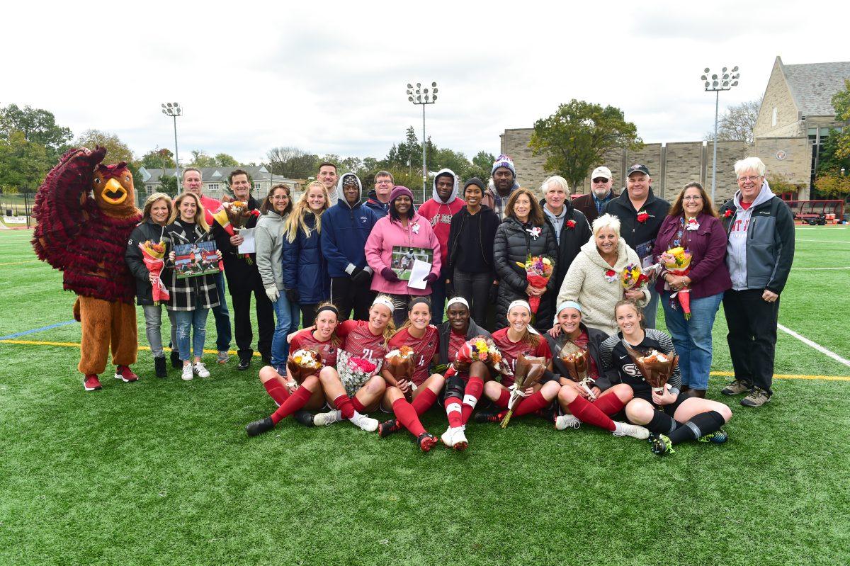 The women’s soccer team and their families pose with the Hawk after their win against St. Bonaventure University (Photo courtesy of SJU Athletics).
