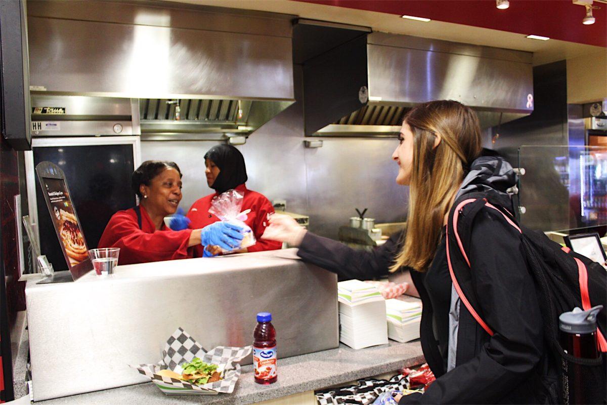 Lexa Fenster ’22 gives candy to a Campion Dining Hall employee (Photos by Rose Barrett ’20).