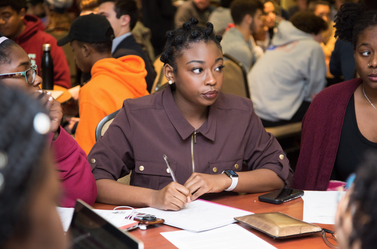 Taylor Stokes '22 takes notes at the small group discussions about a student action plan.  PHOTO: LUKE MALANGA '20/THE HAWK