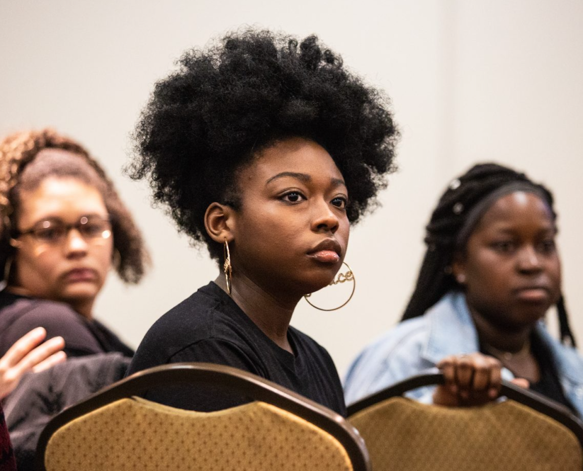 Taylor Stokes ’22 listens to her peers speak at a BSU forum responding to racism on campus. Alyvia Benson ’22 (left) and Camille Lodugnon ’22 (right) sit behind her. PHOTO: LUKE MALANGA ’20/THE HAWK