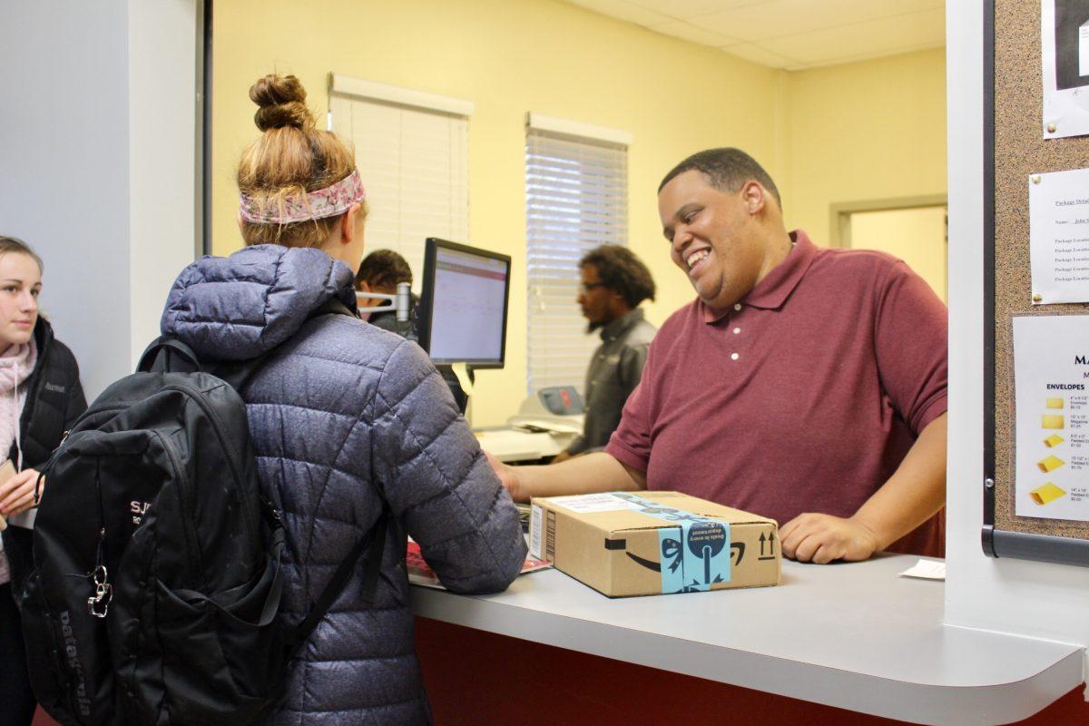 A student receives a package at the new Mail & Package Center. PHOTO: ROSE BARRETT 20