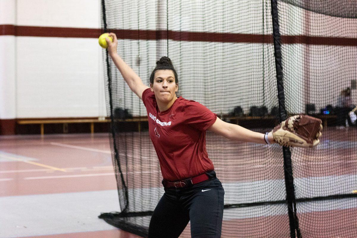 Senior softball pitcher Ashley Ventura winds up for a pitch in Hagan practice gym. 
PHOTO: MITCHELL SHIELDS ’22/THE HAWK