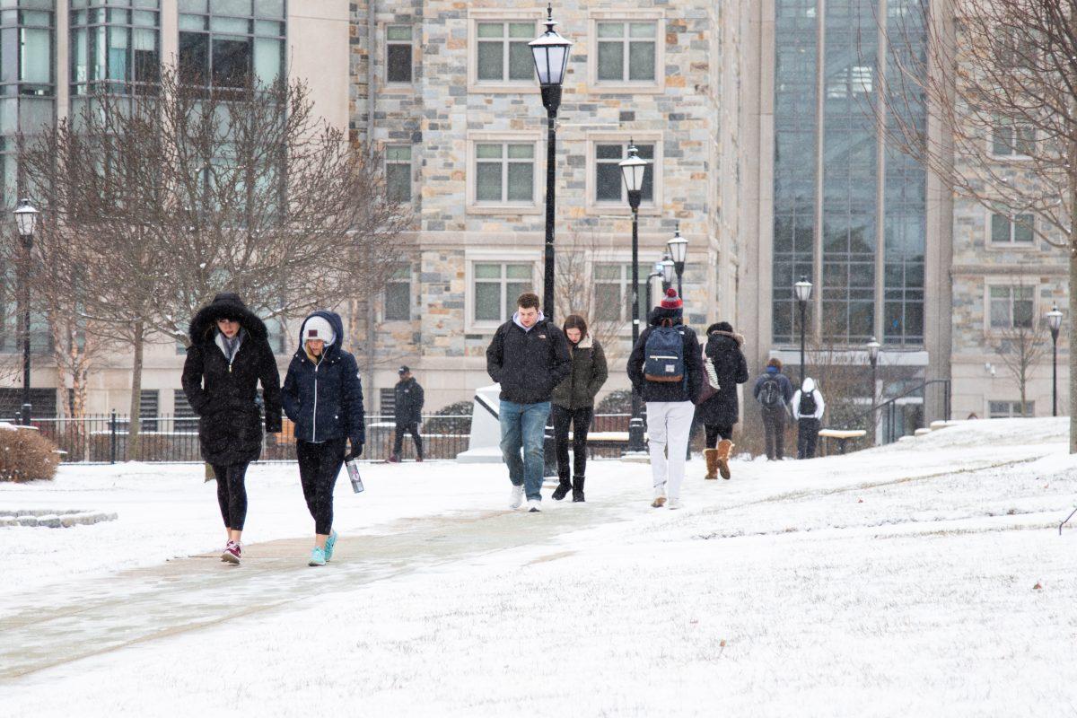 Students cross campus in the snow. PHOTO: MITCHELL SHIELDS 22/THE HAWK