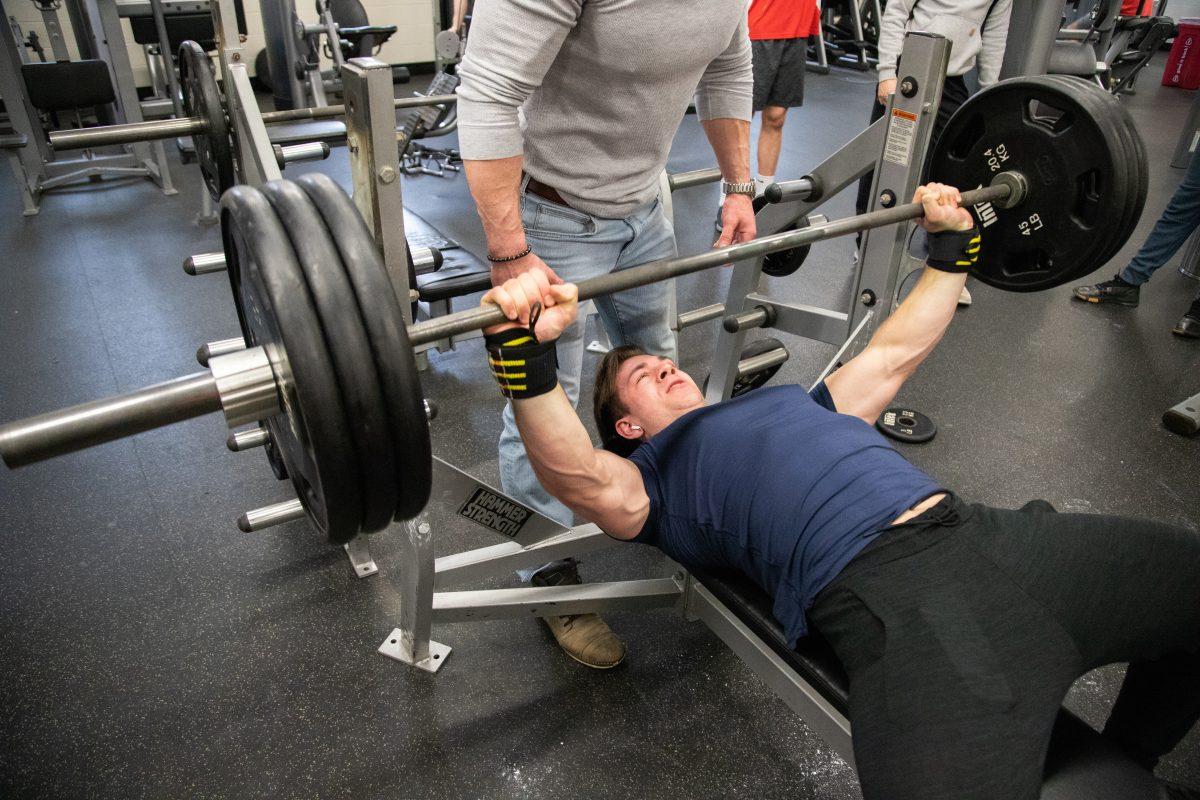 Alex Zalepa ’19 participates in the bench press contest on National Fitness Day. PHOTO: MITCHELL SHIELDS ’22/THE HAWK 