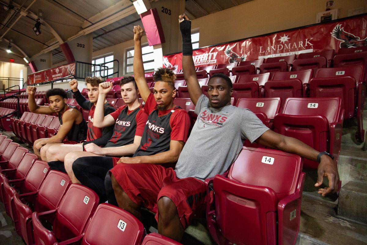 From left to right: Jared Bynum, Mike Muggeo, Taylor Funk, Charlie Brown Jr., and Markell
Lodge sit in the row Phil Pops Martelli sat in during practices, saluting him. PHOTOS: MITCHELL SHIELDS 22/THE HAWK