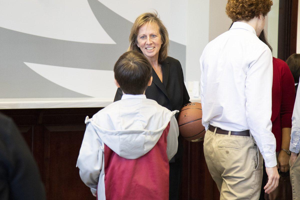 Marie Wozniak interacts with the family of newly appointed men's basketball head coach, Billy Lange. PHOTO: MITCHELL SHIELDS '22/THE HAWK