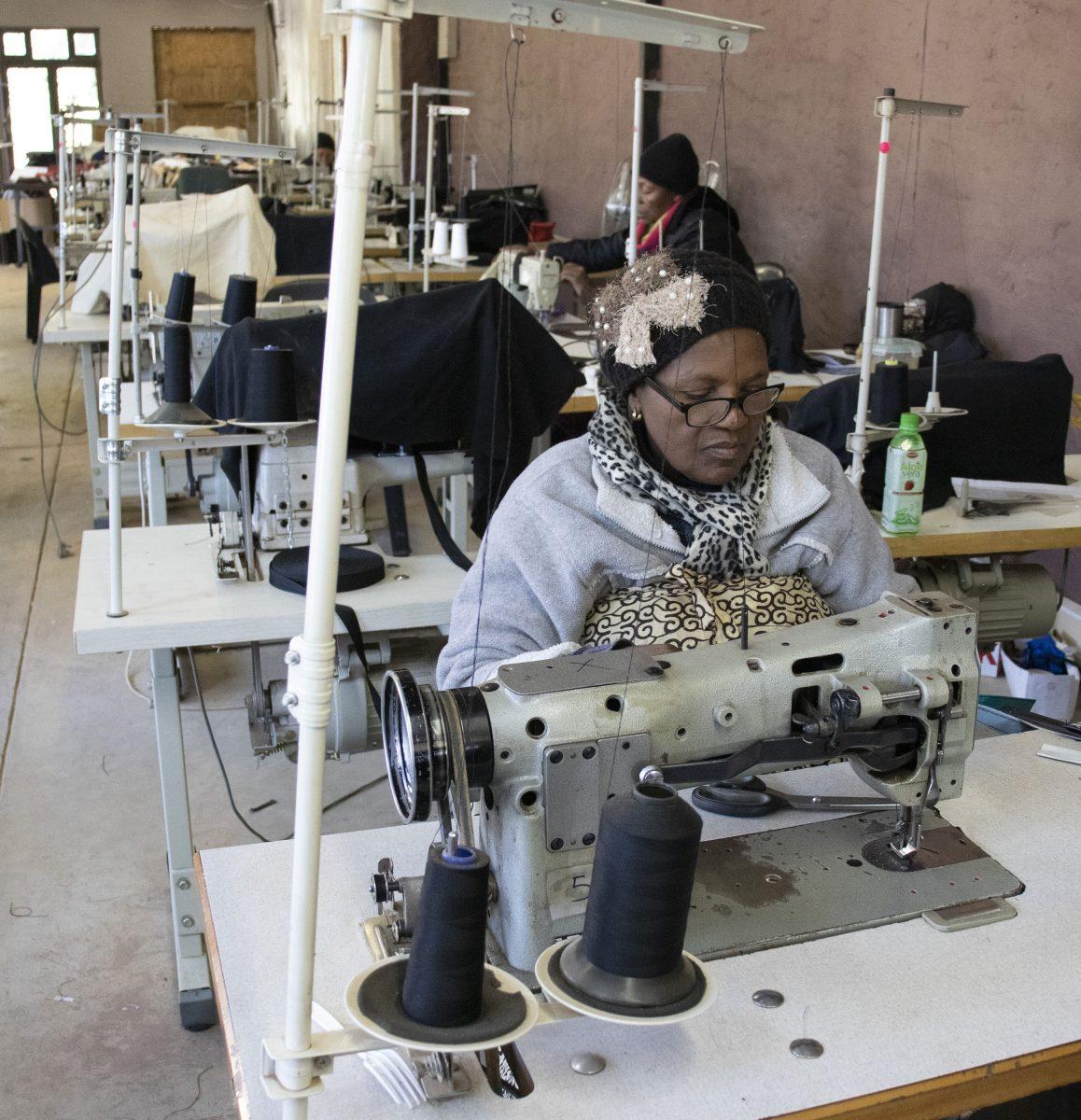 A worker at the I Love Diepsloot factory sews pieces of old billboard together to create a bag. PHOTO: Ana Faguy 19