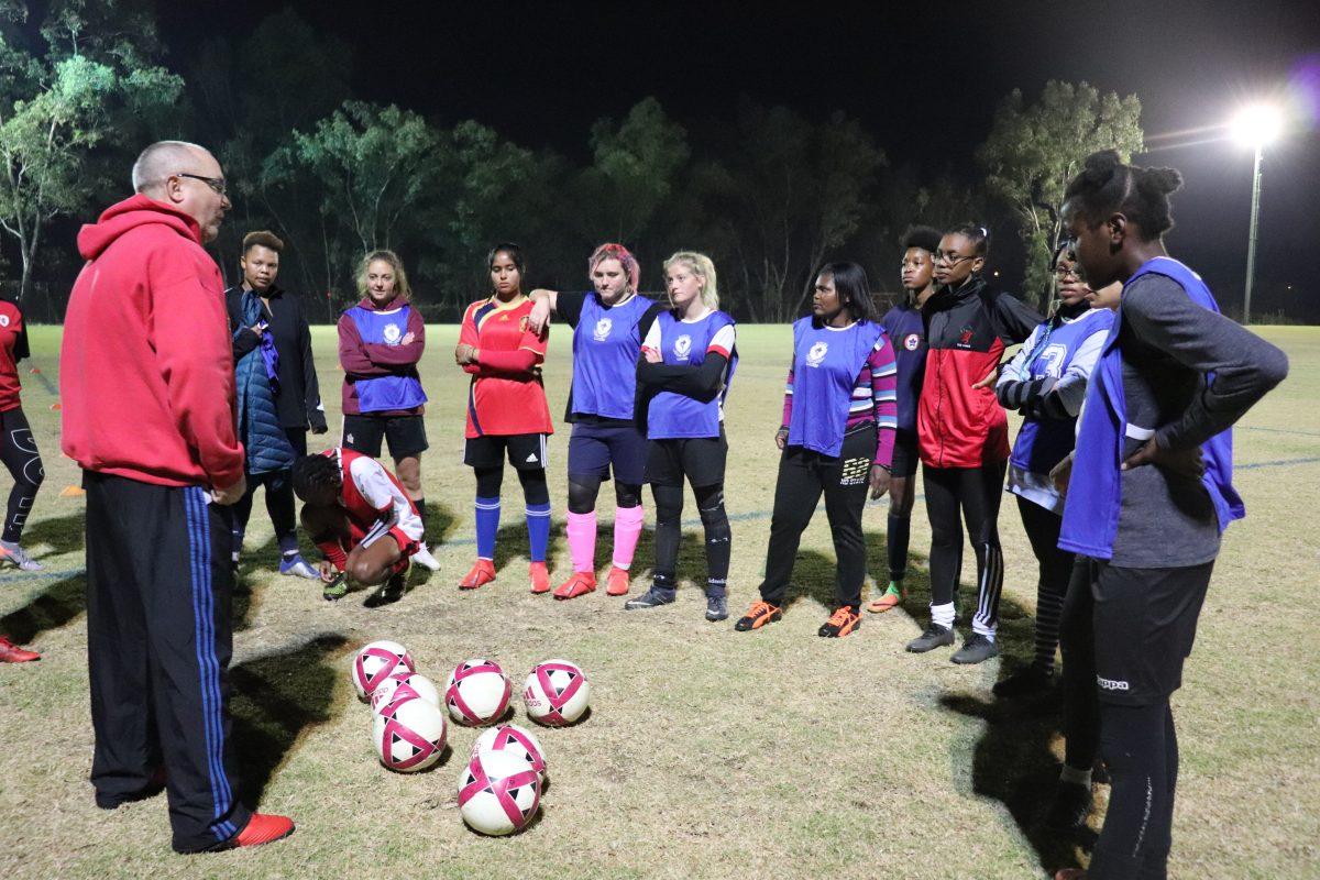 At the Old Parks Soccer Club in Randburg, South Africa, Head Coach Jayson Francis talks to players on the clubs all-female team before an evening practice.  PHOTO: Carly Calhoun 21