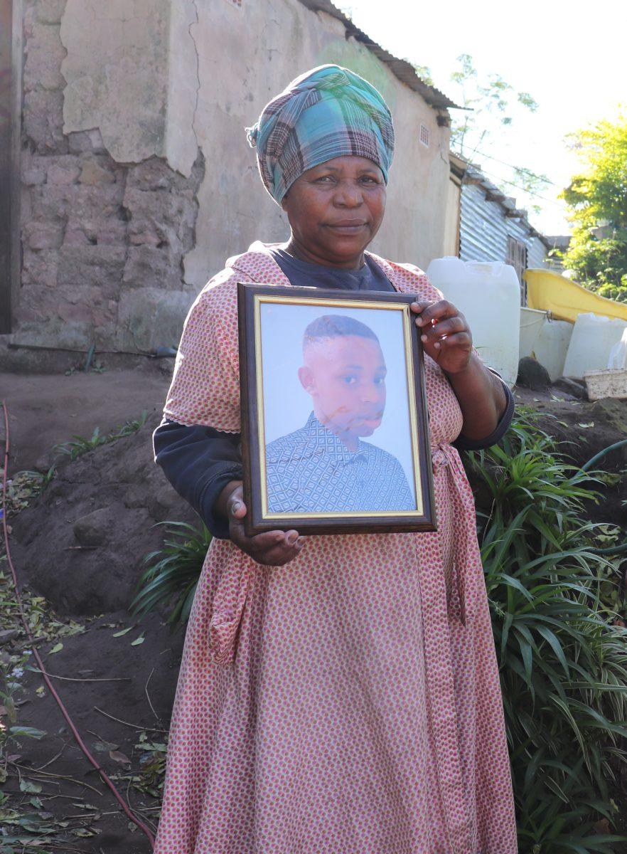 Eunice Mthethwa holds a picture of her 14-year-old grandson, Velani, who was killed in the April floods. PHOTO: Sarah Harwick '21