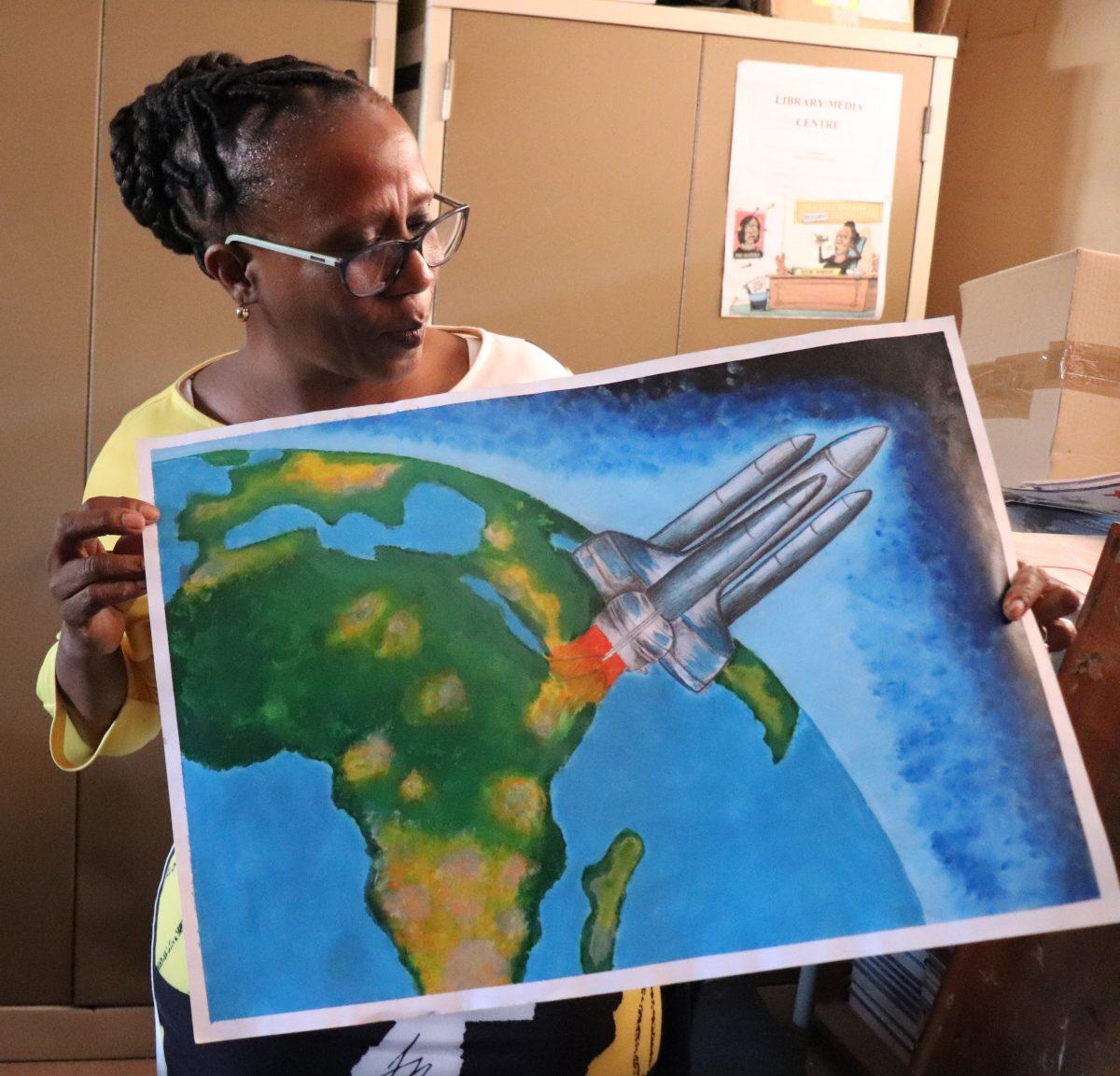 Educator Zanele Nsindane displays her student's art. PHOTO: Sarah Harwick '21
