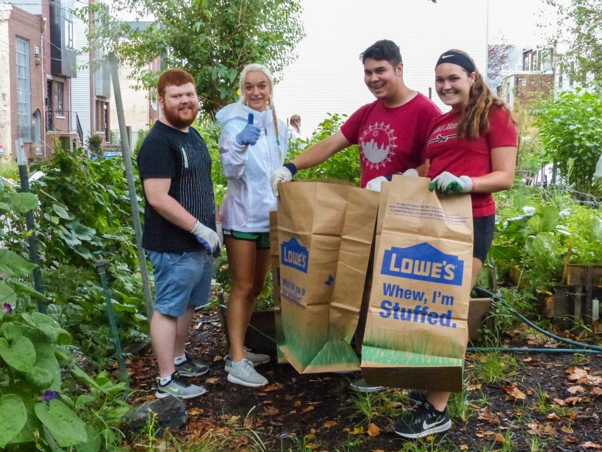 Students participate in service work in a community garden. PHOTO: Courtesy of William Rickle, S.J.