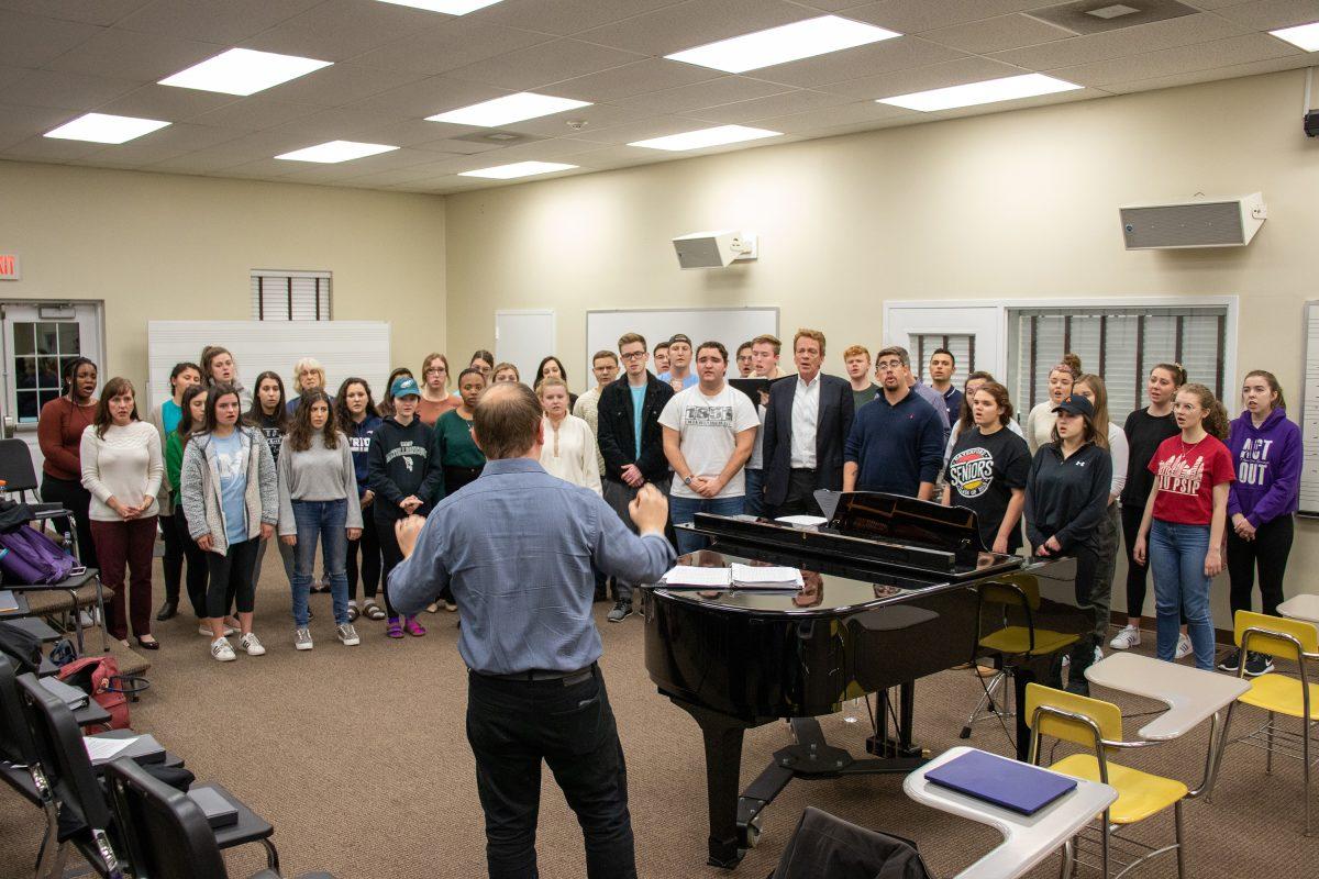 Grammy award winner John Grecia, center, leads the choir’s Monday night rehearsals as its new director. PHOTO: Daniel Remishevsky ’23