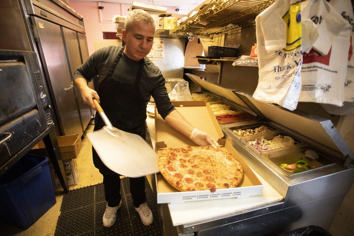 Dashi Hebeja, the owner of La Casa Bella, prepares pizza for customers. PHOTO: MITCHELL SHIELDS ’22/THE HAWK