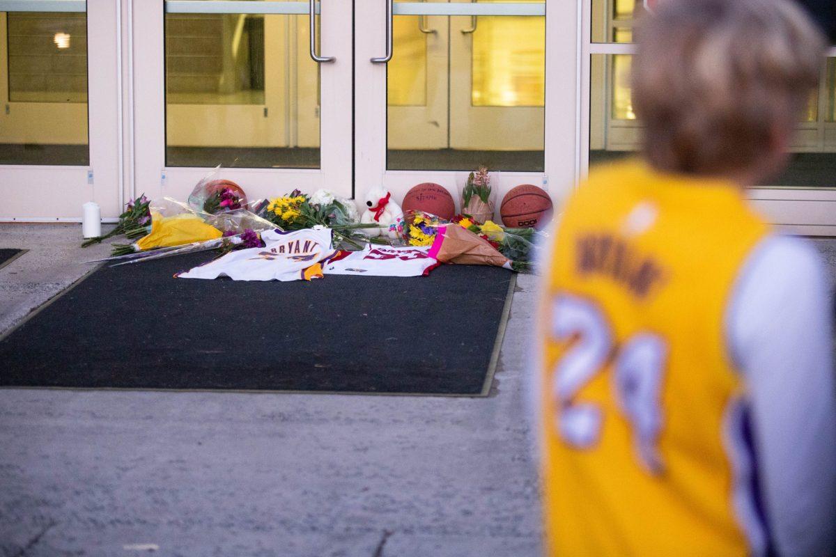 The memorial grew in front of the main doors to Bryant Gymnasium throughout the evening. PHOTO: MITCHELL SHIELDS 22/THE HAWK