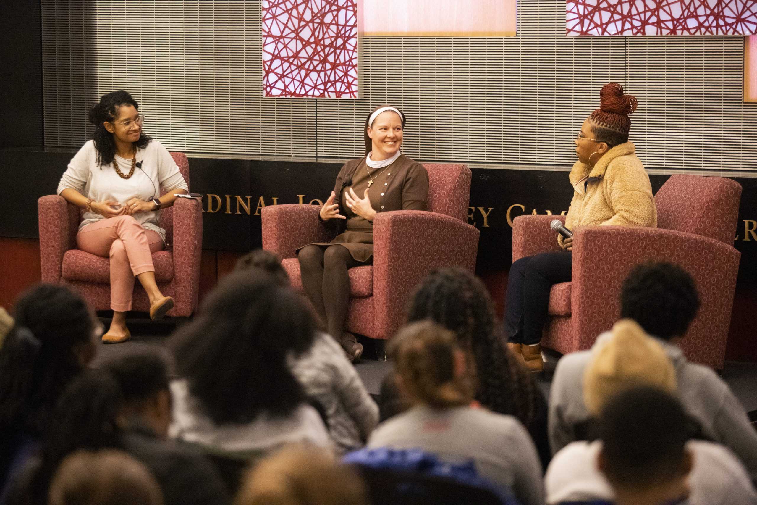 From left to right: Dawn Araujo-Hawkins, Sister Alison McCrary and Lezley McSpadden speak in the Cardinal Foley Campus Center on Feb 5. PHOTO: MITCHELL SHIELDS ’22/THE HAWK