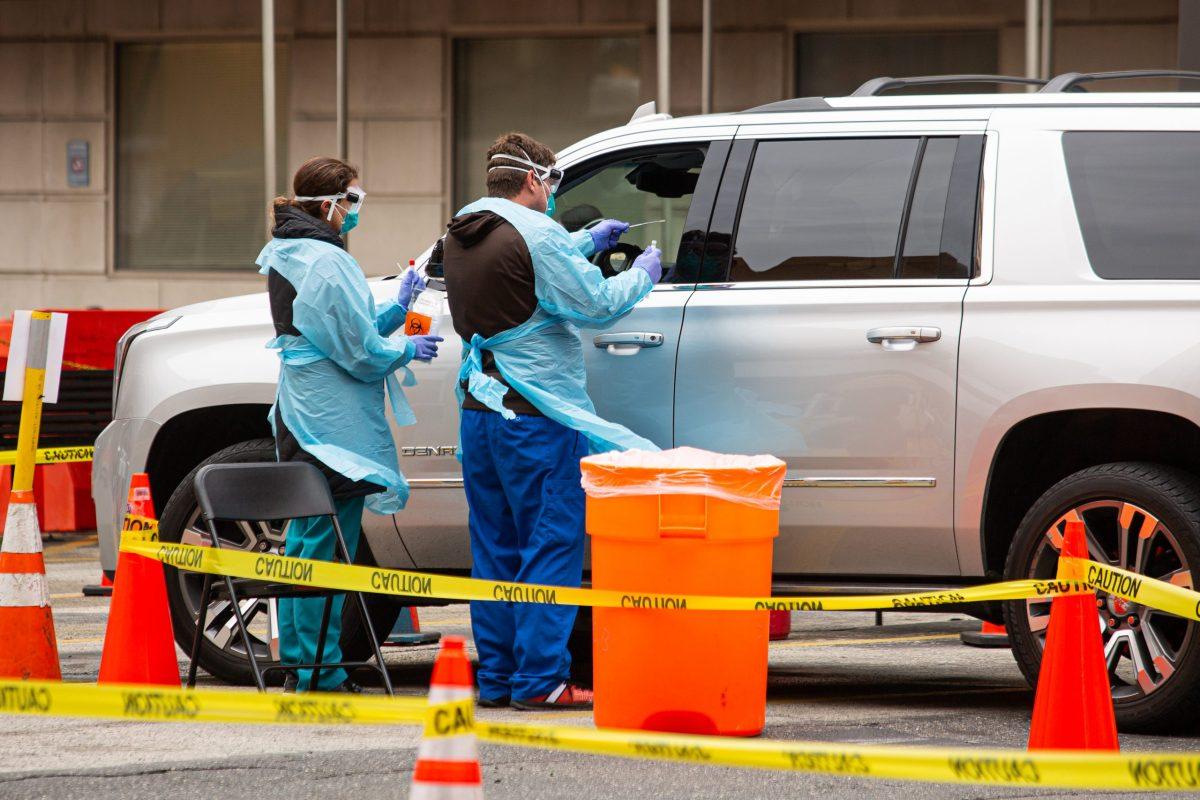 Medical workers test a patient at a drive-thru testing facility run by Thomas Jefferson University Hospital, in Philadelphia, Pennsylvania on March 17. PHOTO: LUKE MALANGA 20/THE HAWK 